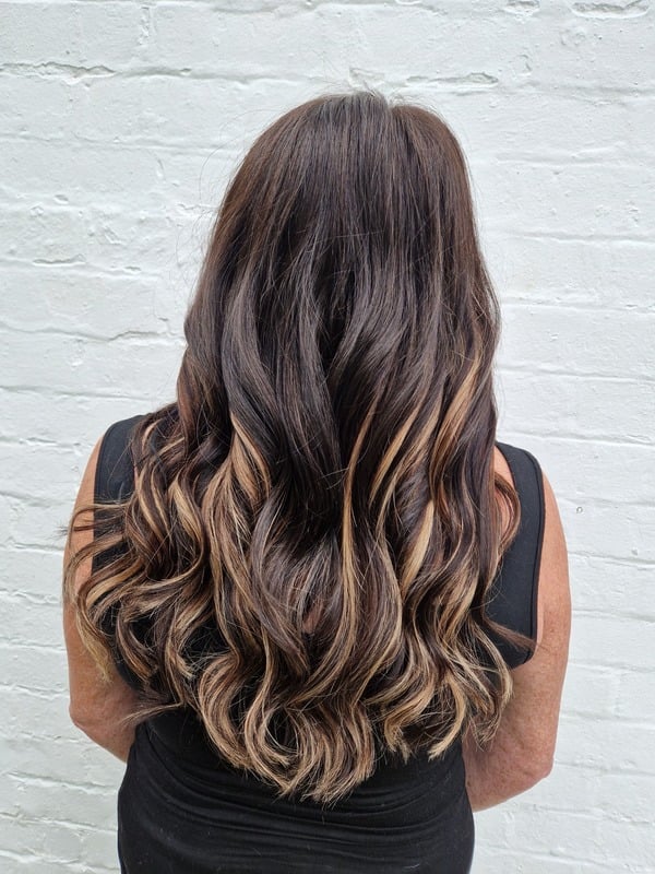 Back view of thick waved hair after extensions