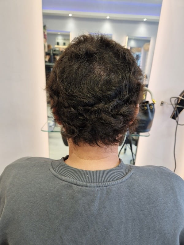 Full, natural-looking hair on a man after a hair system